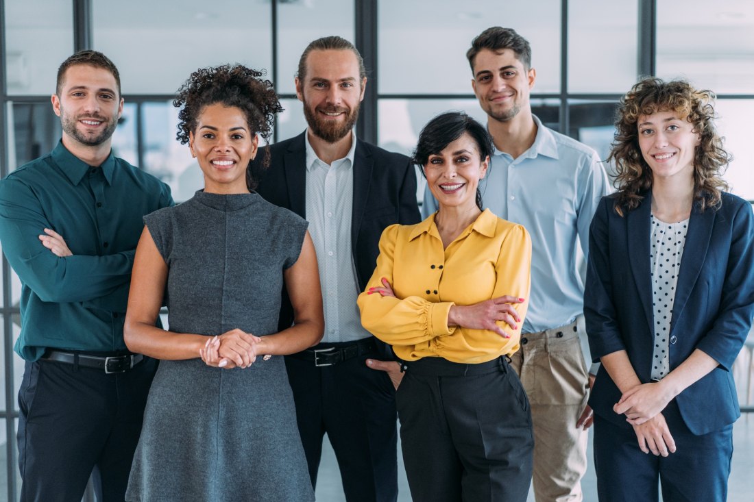 A group of coworkers standing together in an office